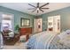 Relaxing bedroom with a ceiling fan, sitting area, dresser, and soft, neutral tones at 489 Open Hill Ave, Henderson, NV 89011