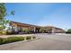 View of community building with covered entrance and ample parking, surrounded by trees and green landscaping at 489 Open Hill Ave, Henderson, NV 89011