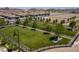 Aerial view of a community park with green grass, mature trees, walking paths, and a fence surrounding the perimeter at 489 Open Hill Ave, Henderson, NV 89011