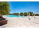Luxurious community pool area with umbrellas, trees, and mountains in the background at 489 Open Hill Ave, Henderson, NV 89011