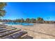 Relaxing community pool area with comfortable lounge chairs and umbrellas at 489 Open Hill Ave, Henderson, NV 89011
