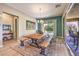 Bright dining room with a large wooden table, benches, stylish rug, and sliding doors to the patio at 489 Open Hill Ave, Henderson, NV 89011