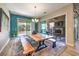Bright dining room with natural wood table, bench seating, modern lighting, and views of the outdoor living area at 489 Open Hill Ave, Henderson, NV 89011