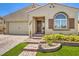 Charming single-story home featuring a well-manicured lawn, desert landscaping, and a two-car garage at 489 Open Hill Ave, Henderson, NV 89011