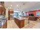 Open floorplan view of kitchen featuring a large island and stainless steel appliances connecting to the living area at 489 Open Hill Ave, Henderson, NV 89011
