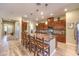 Gourmet kitchen featuring a large island with seating, stainless appliances, and rich wood cabinetry at 489 Open Hill Ave, Henderson, NV 89011