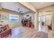 Spacious living room with wood-look tile flooring, a ceiling fan, and an office space nearby at 489 Open Hill Ave, Henderson, NV 89011