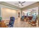 Open concept living room boasts wood-look tile flooring, a ceiling fan, and natural light at 489 Open Hill Ave, Henderson, NV 89011