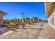Inviting outdoor patio featuring stylish tables, chairs, and shade umbrellas under a clear blue sky at 489 Open Hill Ave, Henderson, NV 89011
