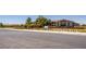 Exterior view of the community's sales center and information building, with well-maintained landscaping and signage at 489 Open Hill Ave, Henderson, NV 89011