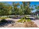 Community tennis courts surrounded by lush landscaping, mature trees, and benches for relaxing between matches at 489 Open Hill Ave, Henderson, NV 89011