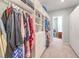 Spacious walk-in closet with custom shelving, drawers, and ample storage space, and a glimpse of the laundry room at 489 Open Hill Ave, Henderson, NV 89011