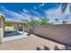Large backyard featuring gravel, block wall fencing, a covered patio and a grill at 5116 Blue Onion Cir, North Las Vegas, NV 89031