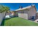 Backyard with artificial turf, gravel, covered patio, and block wall fencing at 5116 Blue Onion Cir, North Las Vegas, NV 89031