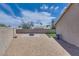 A beautiful backyard featuring gravel, a paver patio with fire pit, and artificial turf at 5116 Blue Onion Cir, North Las Vegas, NV 89031