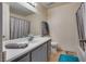 Clean bathroom includes vanity with sink and mirror, tile flooring, tub with shower, and toilet at 5116 Blue Onion Cir, North Las Vegas, NV 89031