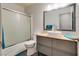 Modern bathroom features a vessel sink, granite countertops, a large mirror, and a glass shower door at 5116 Blue Onion Cir, North Las Vegas, NV 89031