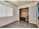 Bedroom featuring hardwood floors, window with blinds, closet, and plenty of natural light at 5116 Blue Onion Cir, North Las Vegas, NV 89031
