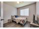 Cozy bedroom with hardwood floors, window with blinds, and a neutral color scheme at 5116 Blue Onion Cir, North Las Vegas, NV 89031