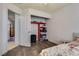 Well-lit room with hardwood floors and organized closet space for easy living and storage solutions at 5116 Blue Onion Cir, North Las Vegas, NV 89031
