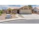 Single-story home with desert landscaping, covered entry, and a two-car garage at 5116 Blue Onion Cir, North Las Vegas, NV 89031