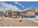 A single-story house featuring desert landscaping and a two-car garage at 5116 Blue Onion Cir, North Las Vegas, NV 89031