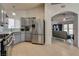 Modern kitchen with stainless steel refrigerator and stove, grey cabinets and tile backsplash at 5116 Blue Onion Cir, North Las Vegas, NV 89031