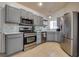 Well-equipped kitchen featuring stainless steel appliances, ample gray cabinetry, and tile backsplash at 5116 Blue Onion Cir, North Las Vegas, NV 89031