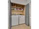Convenient laundry closet with washer and dryer, shelving and bi-fold doors at 5116 Blue Onion Cir, North Las Vegas, NV 89031