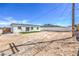 View of the home's back exterior with new grass and a large backyard at 5200 Blanton Dr, Las Vegas, NV 89122