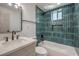 Modern bathroom showcasing a tub, vanity, and elegant teal tiling at 5200 Blanton Dr, Las Vegas, NV 89122