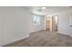 A view of the bedroom features neutral carpet with an ensuite bathroom and walk-in closet at 5200 Blanton Dr, Las Vegas, NV 89122