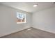 This bedroom features neutral carpet, white walls, trim and a single window at 5200 Blanton Dr, Las Vegas, NV 89122