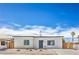 Charming single-story home with a minimalist landscape and bright blue front door at 5200 Blanton Dr, Las Vegas, NV 89122