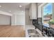 Kitchen with stainless sink and fixtures, gray cabinets and open concept to living room at 5200 Blanton Dr, Las Vegas, NV 89122