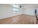 Spacious living room with wood-look flooring, natural light, and modern ceiling fan at 5200 Blanton Dr, Las Vegas, NV 89122