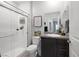 Bathroom with a glass shower, dark cabinets, granite counters, and modern fixtures at 5234 Savannah Rose St, Las Vegas, NV 89149