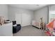 Well-lit Bedroom featuring a crib, chair, and closet space at 5234 Savannah Rose St, Las Vegas, NV 89149