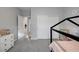 Neutral toned bedroom with a black canopy bed frame, closet with sliding doors and a dresser at 5234 Savannah Rose St, Las Vegas, NV 89149