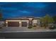 Charming single story home at dusk featuring a three car garage and landscaped front yard at 5234 Savannah Rose St, Las Vegas, NV 89149