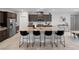 Open concept kitchen featuring a large island, barstool seating, and dark cabinetry at 5234 Savannah Rose St, Las Vegas, NV 89149