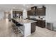 Modern kitchen boasts a large island with seating, granite countertops, and stainless steel appliances at 5234 Savannah Rose St, Las Vegas, NV 89149