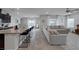 Open concept kitchen featuring granite countertops, dark cabinets, and stainless steel appliances at 5234 Savannah Rose St, Las Vegas, NV 89149