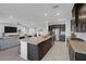 Bright open kitchen with granite counters, stainless appliances and an expansive island with bar stool seating at 5234 Savannah Rose St, Las Vegas, NV 89149