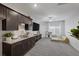 Spacious living room with granite counters, dark cabinets, and carpet flooring at 5234 Savannah Rose St, Las Vegas, NV 89149