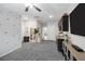 A spacious living room with neutral colors, a kitchenette, and modern decor at 5234 Savannah Rose St, Las Vegas, NV 89149