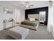 Well-lit main bedroom with an upholstered bed, modern lighting, and soft carpet at 5234 Savannah Rose St, Las Vegas, NV 89149
