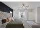 Well-lit main bedroom featuring a gray upholstered bed and soft carpet at 5234 Savannah Rose St, Las Vegas, NV 89149