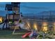 Backyard playground featuring a swing set with mountain views, a slide, and other play equipment at 5234 Savannah Rose St, Las Vegas, NV 89149
