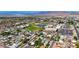 Wide aerial view showcases a community with houses, a park, schools, and sports facilities at 524 Hopi Pl, Boulder City, NV 89005
